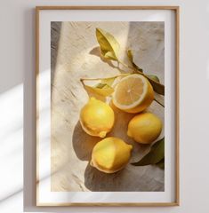 some lemons are laying on top of each other in front of a white wall