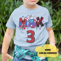 a young boy wearing a blue shirt with the name max 3 on it's chest