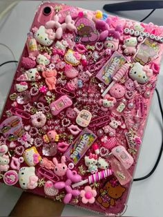 an ipad covered in hello kitty and other items