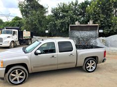 a silver truck is parked in the dirt