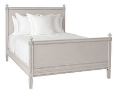 a white bed sitting next to a night stand