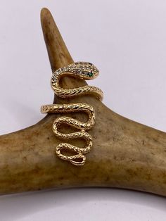 This beautifully crafted, Vintage Snake Serpent Ring is made of 9k Gold Filled. Perfect for adding a touch of mystique to any outfit, this remarkable cocktail ring features an intricate snake serpent design. The ring is embellished with sparkling Cubic Zirconia stones, elegantly set in a 9k gold filled band.   It's designed to be adjustable, ensuring a comfortable fit for anyone. This unique piece has been skillfully re finished, resurrected from a vintage collection. Additionally, you have the Serpent Ring, Crystal Diamond, Snake Ring, Gold Snake, Stylish Gifts, Diamond Crystal, Diamond Gemstone, Statement Ring, Vintage Gold