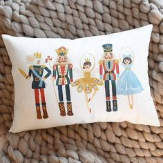 a pillow with an image of nutcrackers and princesses on the front