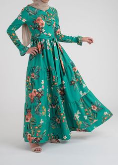 Modest Flowy A-line Dress, Green Maxi Dress With Gathered Sleeves, Modest Empire Waist Maxi Dress, Modest Billowy Maxi Dress, Billowy Long Sleeve Floral Maxi Dress, Flowy Long Sleeve Maxi Dress For Garden Party, Modest Flowy Floral Dress With Ruffles, Modest Maxi Dresses With Gathered Sleeves, Modest Flowy Maxi Dress With Empire Waist