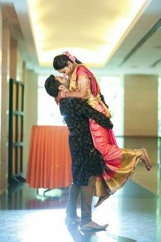 a man and woman dance together in an empty room