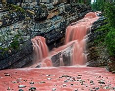 red water flowing down the side of a waterfall