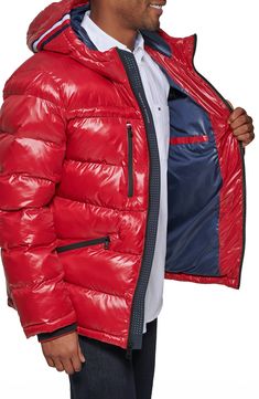 Stay warm in this shiny water-resistant puffer jacket constructed with a grosgrain striped hood, secure zip pockets and ribbed storm cuffs. 29 1/2" length Front zip closure Fixed hood Long sleeves with ribbed cuffs Chest zip pockets; front zip pockets; interior welt pocket Lined, with 100% polyester fill Shell is 100% nylon; cuffs are 97% polyester, 3% spandex Machine wash, tumble dry Imported Model stats: 6'1" height, 32" waist. Model is wearing size Medium. Tommy Hilfiger Store, Hooded Puffer Jacket, Red Fits, Tom Ford Sunglasses, Sweaters And Leggings, Comfortable Sandals, Tommy Hilfiger Man, Tommy Jeans