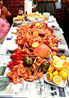 the table is covered with lobsters and lemons