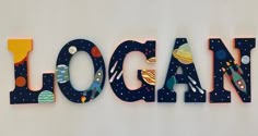 an image of the word local written in wood letters with space and planets on them