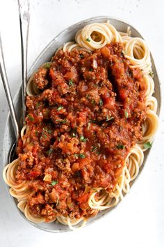 a bowl filled with spaghetti and meat sauce