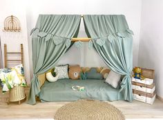 a child's bedroom with a canopy bed and teddy bears on the floor in front of it