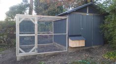 a chicken coop in the middle of some trees