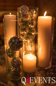 candles and ornaments are sitting on a table with the words q events written below them