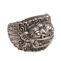 Deriving his inspiration from Balinese art and literature Nyoman Rena sculpts sterling silver into a portrait of Barong. Legend says Barong's fierce face hides his benevolent nature for he represents the goodness that destroyed the evil witch Rangda. Rena presents the beloved figure as a men's ring. .925 Sterling silver Ceremonial Silver Carved Rings, Ceremonial Carved Silver Rings, Ceremonial Artisan Sterling Silver Rings, Artisan Sterling Silver Rings For Ceremonial Occasions, Artistic Silver Ring Collectible, Balinese Art, Evil Witch, Art And Literature, Sterling Silver Rings Bands