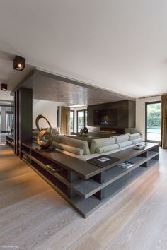 a large living room with white couches and wooden floors