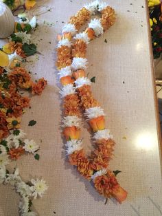 flowers laid out on a table to be used as garland