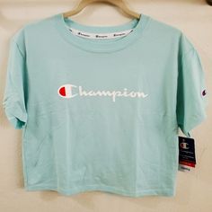 Champion, Heritage Cropped Tee, Script Logo Light Blue X-Small Soft, Heavyweight 7 Oz. All Cotton Jersey. Loose, Boxy Fit Through The Body With Relaxed Dropped Shoulders. Cropped 20-Inch Length. Double-Needle Construction Throughout C Patch Logo On Sleeve. Fabric: Solid Body: 100% Cotton; Heathers: 75% Cotton/25% Polyester Casual Blue Crop Top With Letter Print, Blue Sporty Cropped T-shirt For Spring, Blue Graphic Tee Crop Top With Letter Print, Blue Letter Print Cropped T-shirt For Spring, Blue Cropped T-shirt With Letter Print For Spring, Spring Blue Cropped T-shirt With Letter Print, Relaxed Fit Cropped Cotton T-shirt For Sports, Champion Crop, Soft-washed Relaxed Fit Cropped T-shirt