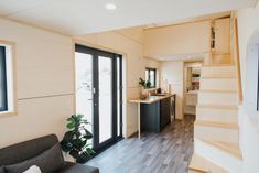 a living room and kitchen area in a tiny home