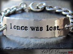 a silver bracelet that says, once was lost