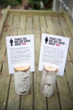 two jars with signs on them sitting on a wooden table