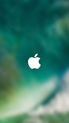 an apple logo is seen on the screen in this image taken from above, with green and blue hues