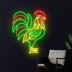 a neon sign with a rooster on it in front of a black wall and chair