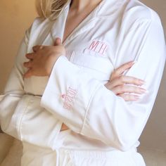 Get ready on your wedding morning, in style with our personalised wedding Pyjamas With Sleeve Embroidery, not to be used for just one day but to keep as a wedding Keepsake.  Beautiful satin pyjamas are a perfect gift for new bride, bride to be or as a perfect addition to your hen/bridal party or to take along on your honeymoon to show off your new initials. They make the perfect gift for a girlfriend, best friend, Daughter or Mum. The pyjamas are embroidered on the front, with your name or initials and on the sleeve with your wedding date or any special date. Please note that the more characters you choose the smaller they will appear.  All our products are personalised in house therefore,  please feel free to send a message if you have any special requests.  The shirt is buttoned up and t White Long Sleeve Sets For Wedding, White Long Sleeve Sets For Wedding Night, White Long Sleeve Wedding Sets, White Long Sleeve Sleepwear For Wedding, White Long Sleeve Sleepwear For Honeymoon, Embroidered Pajamas, Satin Pyjamas, Bridesmaid Pajama Set, Embroidered Robes