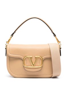 beige calf leather grained texture tonal stitching gold-tone hardware maxi VLogo Signature internal logo stamp foldover top with magnetic fastening adjustable detachable shoulder strap rear patch pocket main compartment internal patch pocket suede lining This piece comes complete with a protective dust bag. Logo Stamp, Valentino Garavani, Leather Crossbody Bag, Leather Crossbody, Patch Pocket, Calf Leather, Crossbody Bag, Dust Bag, Shoulder Strap