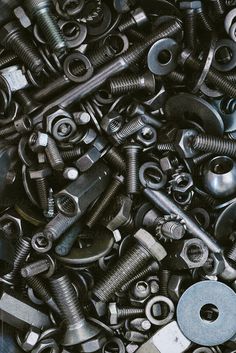 there are many screws and nuts in this pile