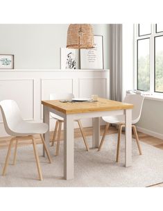 a white table with two chairs and a window in the background, next to a rug