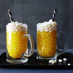 two glass mugs filled with corn on the cob and topped with marshmallows