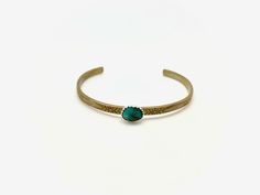 A natural Turquoise stone (8x10mm) is set in a fine silver serrated bezel on a floral, sturdy brass band. Cuff is adjustable, and can be made smaller or larger, perfect for stacking or wearing alone! Turquoise is a stone long associated with protection, luck/good fortune and hope. Adjustable Turquoise Cuff Bracelet With Natural Stones, Turquoise Gemstone Cuff Bracelet As Gift, Luxury Turquoise Cuff Bracelet With Natural Stones, Turquoise Natural Stone Cuff Bangle, Adjustable Hand-tooled Turquoise Cuff Bracelet, Natural Turquoise Stone, Brass Band, Natural Turquoise, Turquoise Stone