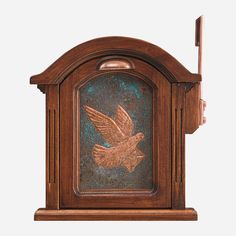 an old wooden clock with a bird on it