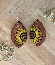 Elevate your accessory game with these stunning hand-painted floral earrings!  Designs are meant to stand out and showcase the intricate floral motifs that celebrate the beauty of the outdoors.  Each pair is meticulously crafted by me, ensuring that no two pairs are exactly alike making them perfect for everyday wear without compromising on style making them great for everyday wear or special occasions.   Crafted from high-quality wood, these earrings are lightweight and comfortable. **VARIOUS STYLES** When ordering please ensure you've selected the correct one.   Materials: wood, genuine leather, paint, and high-quality beads.  Care Instructions: To maintain the beauty of your earrings, avoid exposure to water and store them in a dry place. Gently wipe with a soft cloth to clean.  Shippin Artistic Flower-shaped Jewelry For Crafting, Hand Painted Yellow Earrings For Summer, Adjustable Flower-shaped Nature-inspired Earrings, Nature-inspired Adjustable Flower Earrings, Nature-inspired Flower Earrings, Artistic Drop Earrings For Summer, Hand Painted Dangle Flower Earrings, Unique Hand Painted Flower Drop Earrings, Bohemian Hand Painted Flower Jewelry