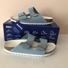 Birkenstock's Signature Arizona Sandals, Now Reimagined In Blue Grained Leather, Were Introduced In 1973 And Have Since Risen To Cult Status. They're Made In The Label's Native Germany. Brand New In Box Sizes: 38eu = 7/7.5us 39eu = 8/8.5us 40eu = 9/9.5us Color: Sky Upper: Natural Nubuk Leather Footbed: Natural Cork Logo-Engraved Buckles Adjustable Straps Eva Rubber Sole Made In Germany. Blue Leather Sandals With Textured Footbed, Blue Leather Footbed Sandals With Textured Insole, Blue Flat Sandals With Cushioned Footbed, Blue Leather Footbed Sandals With Removable Insole, Blue Leather Footbed Sandals With Textured Footbed, Blue Leather Footbed Sandals With Round Toe, Blue Leather Footbed Sandals With Cushioned Footbed, Blue Leather Footbed Sandals For Summer, Blue Flat Heel Sandals With Cushioned Footbed