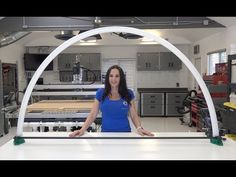 a woman standing in front of a white counter