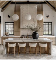 a large kitchen island with four chairs around it