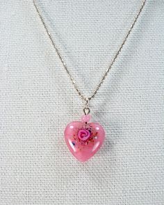 "Delicate Vintage Lampwork Pink Heart Pendant on Sterling 20 Inch Chain  Featured is a delicate, vintage glass lampwork pink heart pendant on a sterling silver chain. This beautiful little heart has a pink rose design created within the glass. The sterling silver 1mm bead chain, measures 20 inches and the pendant measures 5/8 by 7/8 inches. To appreciate this sweet piece, zoom in for details. I hope you've enjoyed looking at my creations. They are so much fun to create! All of my jewelry is crea Rose Heart-shaped Necklace For Gift, Pink Open Heart Necklace For Weddings, Delicate Pink Heart Pendant Jewelry, Pink Rose Design Jewelry For Valentine's Day, Heart-shaped Pink Glass Jewelry, Pink Heart-shaped Glass Jewelry, Pink Sterling Silver Heart Necklace, Dainty Style, Pink Sterling Silver Dainty Heart Necklace, Dainty Pink Heart Sterling Silver Necklace