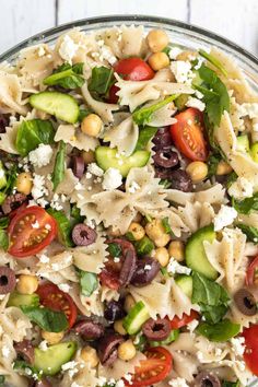 a bowl filled with pasta salad on top of a table