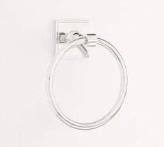 a towel ring hanging on the wall in front of a white background with copy space