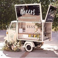 an ice cream truck is decorated with flowers and greenery for a wedding or bridal event