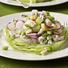 a plate with lettuce and radishes on it