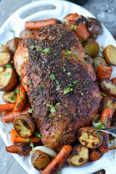 a white plate topped with meat and veggies