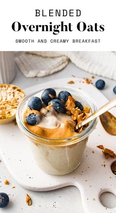 blueberry overnight oats in a glass bowl with spoon