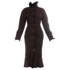 Vivienne Westwood brown shearling coat dress. High neck, signature Westwood Orb buttons, fitted waist and flared skirt. Fall-Winter 1992 Chic Brown Fitted Fur Coat, Brown Fitted Long Fur Coat, Harris Tweed Jacket, Wool Waistcoat, Dress High Neck, Designer Coats, Winter Chic, Shearling Coat, Vintage Coat