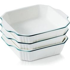 three white dishes stacked on top of each other