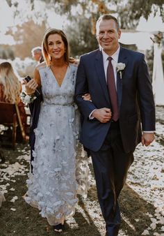 a bride and groom walking down the aisle