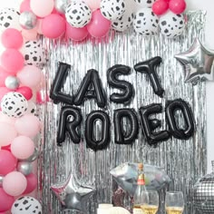 a party with balloons and streamers that say last rodeo on the wall, surrounded by confetti