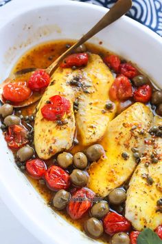 chicken with olives and tomatoes in a white bowl