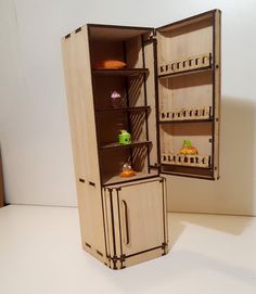 an open refrigerator sitting on top of a white counter